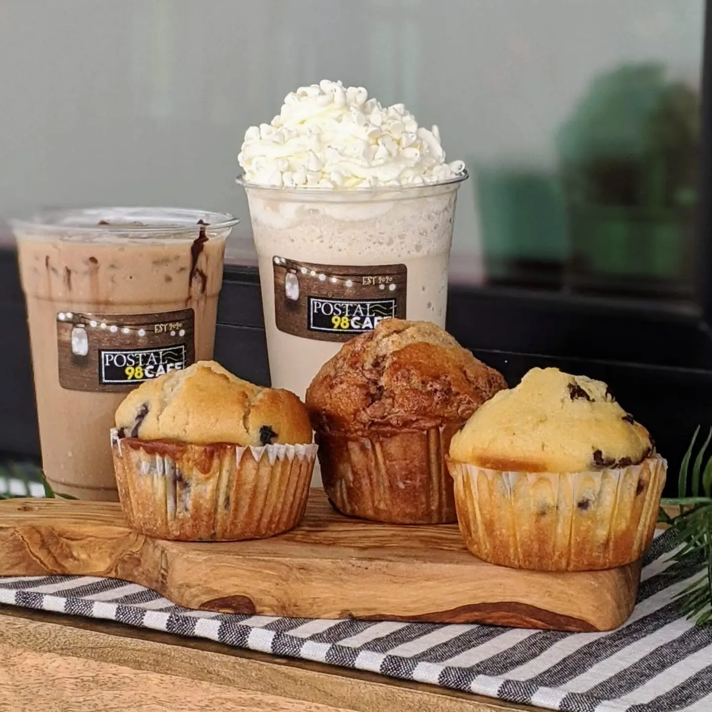 Iced drinks and pastries on the counter at Postal 98 Cafe